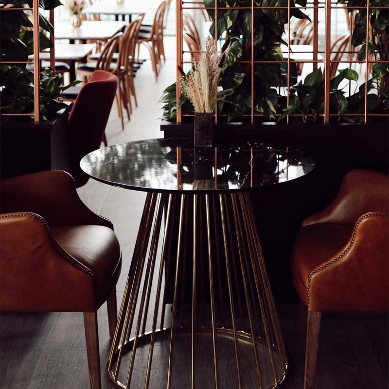 Black marble topped table with gold spiked legs