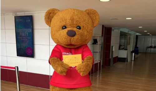 Cookie The Courtyard Bear is a worldrenowned superstar image Cookie holding his signature