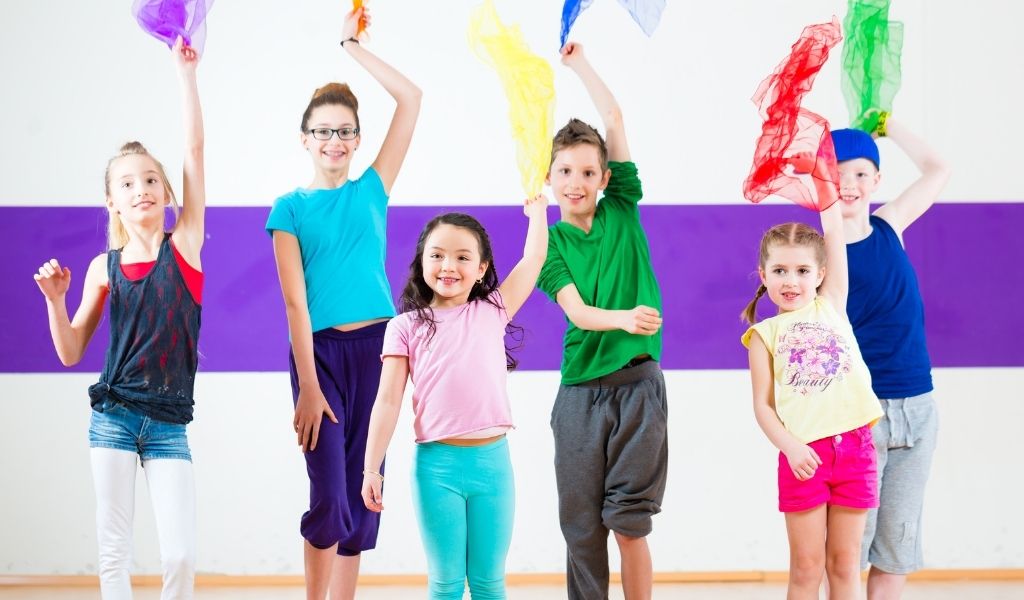 Olympics Facebook Live Week image: Children waving multicoloured handkerchiefs