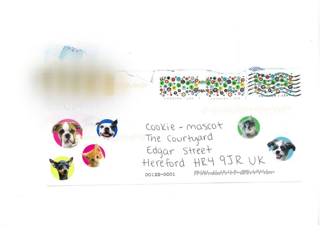 Envelope to The Courtyard from Ramsey in the USA covered in stickers with dogs and cats on.