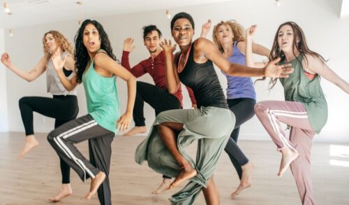 A group of people doing a Zumba class in a gym studio