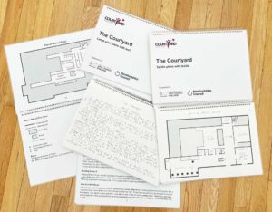Tactile maps of The Courtyard on a wooden floor
