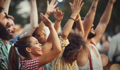 A crowd of people clapping their hands and giving a standing ovation  free theatre tickets for keyworkers image