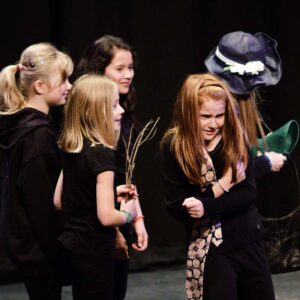 A group of children acting out a Roald Dahl scene