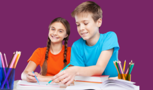 A young girl and boy sat with paper and pencils