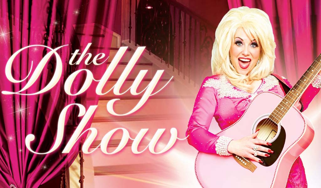 The Dolly Show written in pink, next to a woman dress up as Dolly Patron in a blonde wig, holding a pink guitar. Pink curtains in the background.