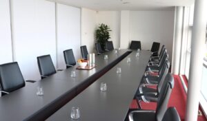 Meeting Room 2 set up with black boardroom table and black leather chairs
