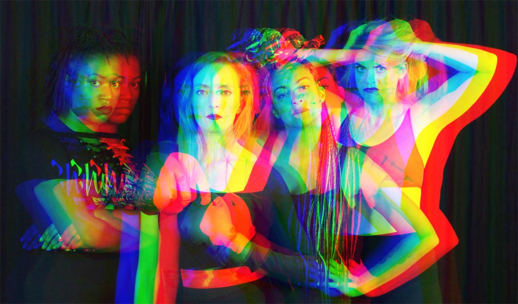 Badass Medusa - four women stood looking fiercely at the camera with a rainbow effect
