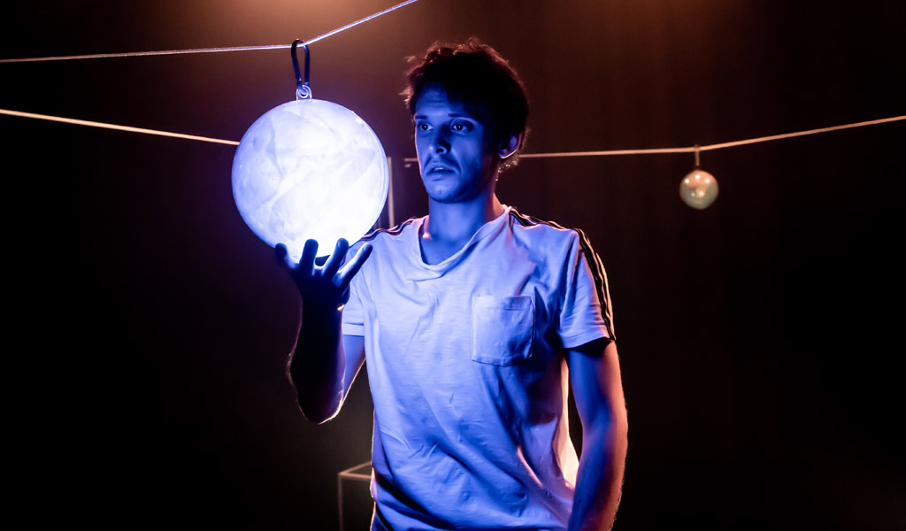 A man holding a glowing orb of light