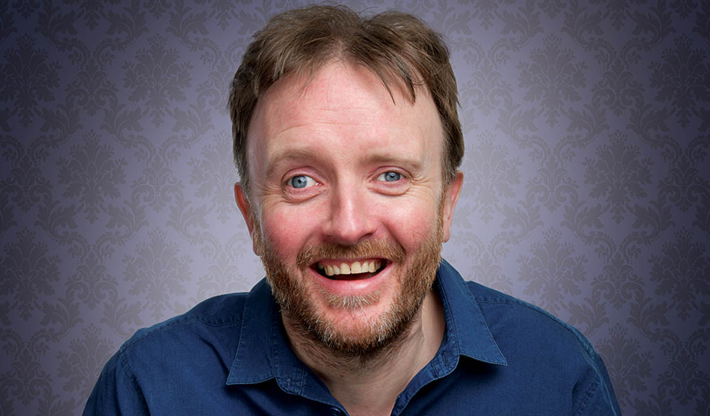 Chris McCausland smiling at the camera