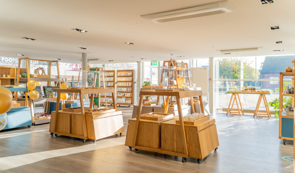 An image of the shop - wooden stands with gifts on in the sunlight