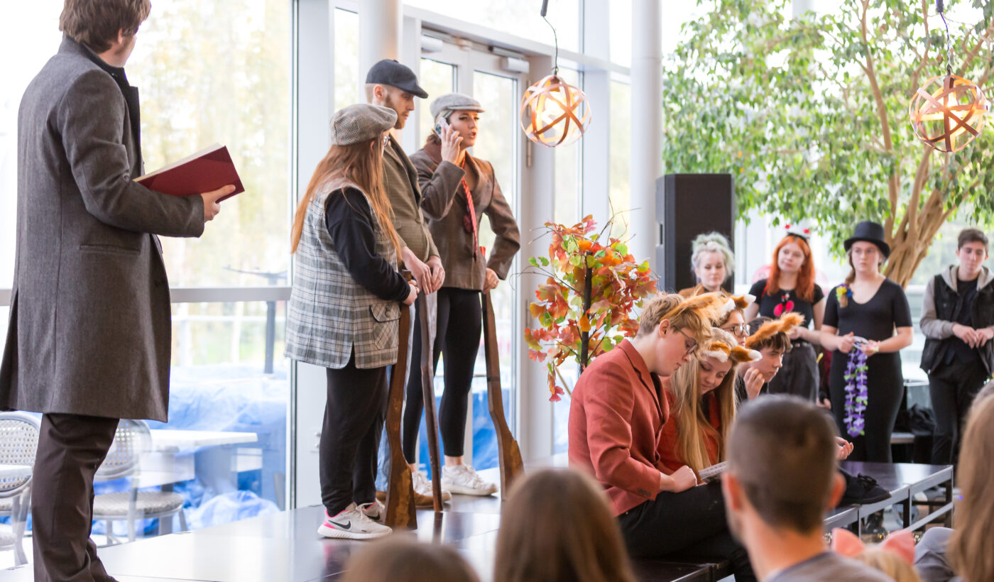 Magic & Mischief - four people onstage dressed in fancy dress in front of an audience