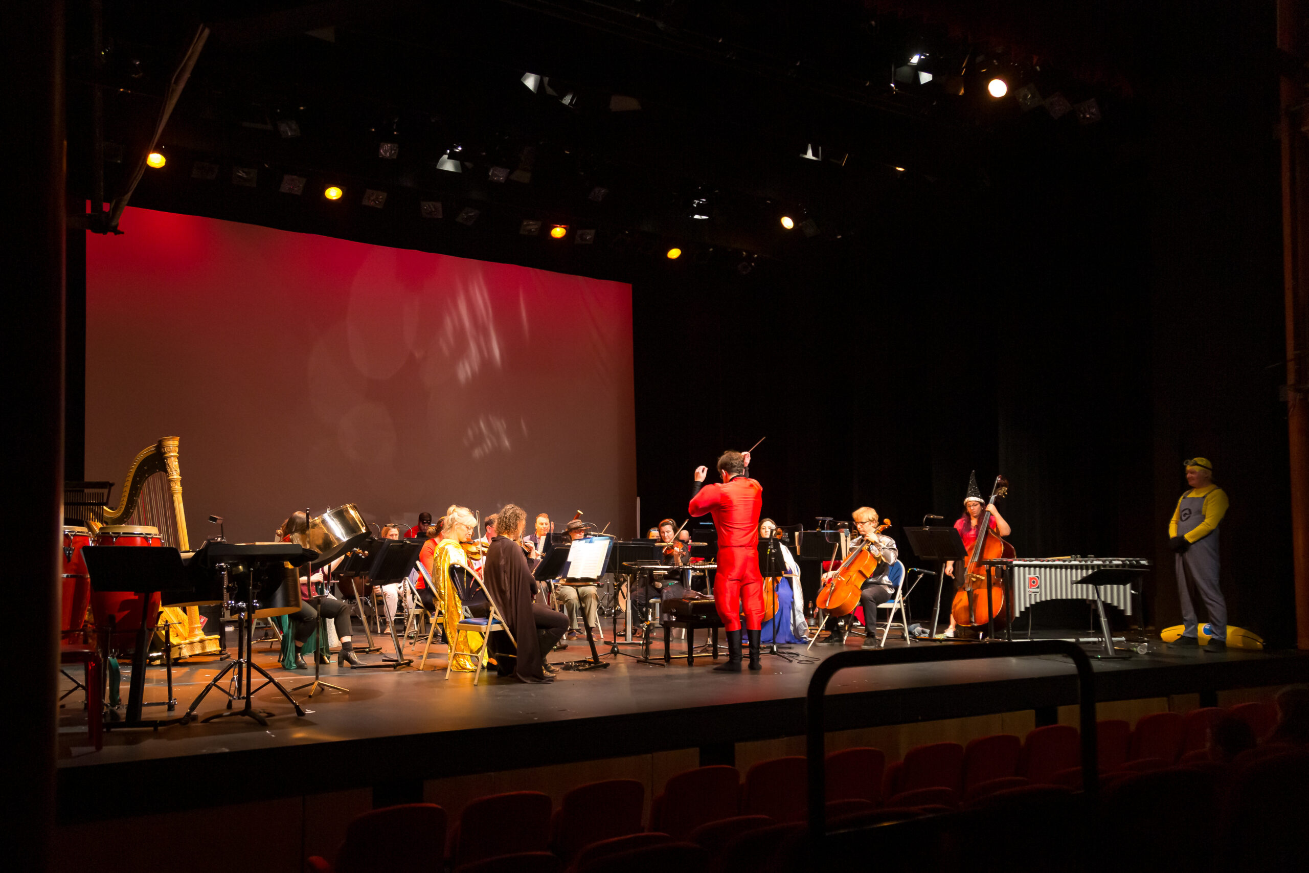Orchestra Of The Swan brings movie magic to The Courtyard: An orchestra in fancy dress playing in front of a screen and lights