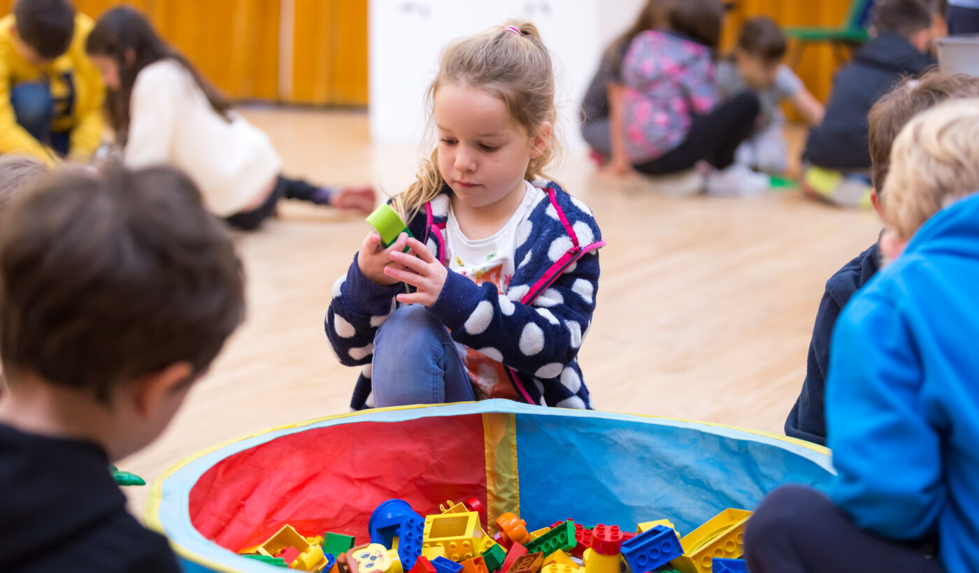 A little girl playing with lego 