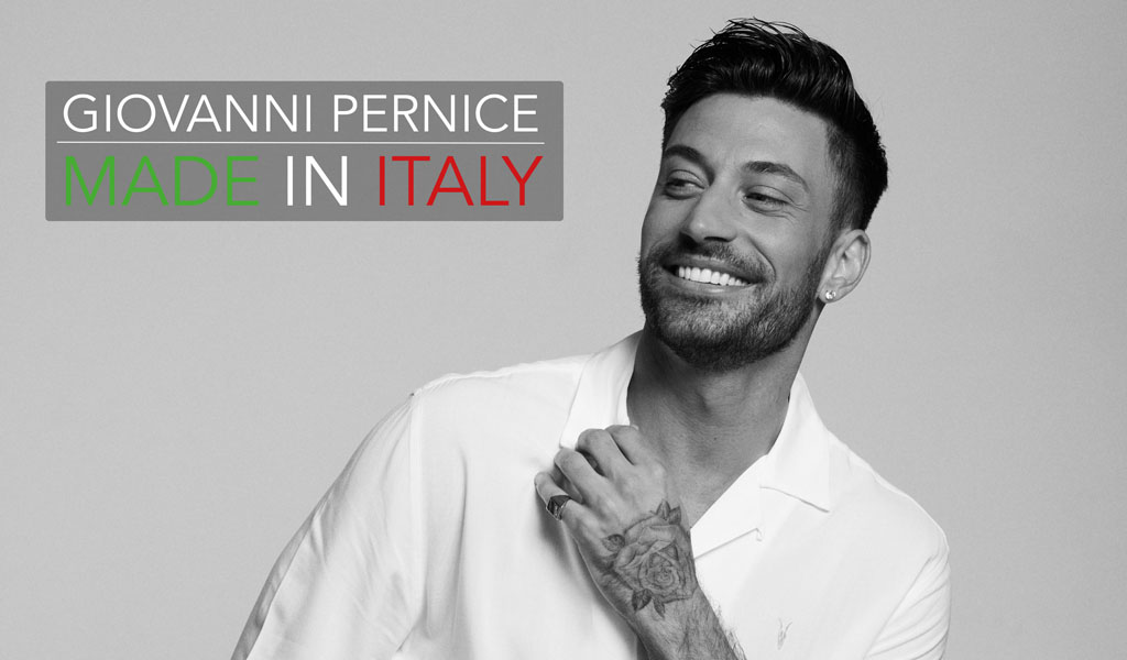 A black and white image of Giovanni Pernice in a shirt, smiling with the title Giovanni Pernice Made In Italy written in green, white and red
