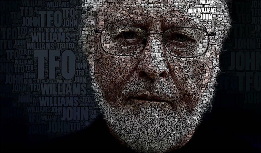 John Williams - Movie Music Maestro - a close up of an older mans face with a white beard and glasses