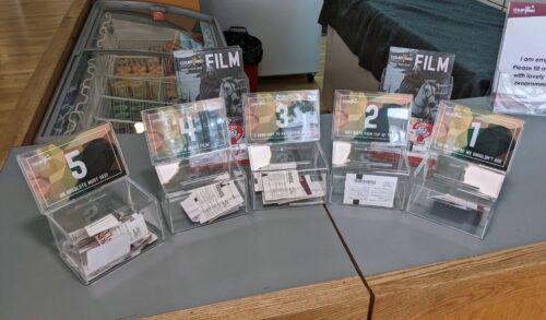Clear boxes numbered 1 to 5 sit next to the studio theatre entrance Inside the boxes are film tickets which customers have used to vote with