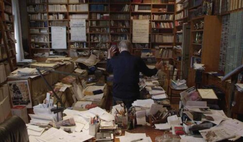 Ennio Image  Ennio Morricone stands with his back to the camera in a room filled with sheet music
