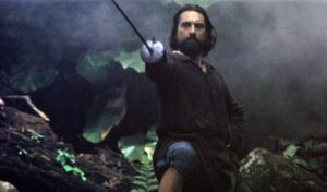 The Mission, Image - Robert De Niro stands in a jungle holding a sword