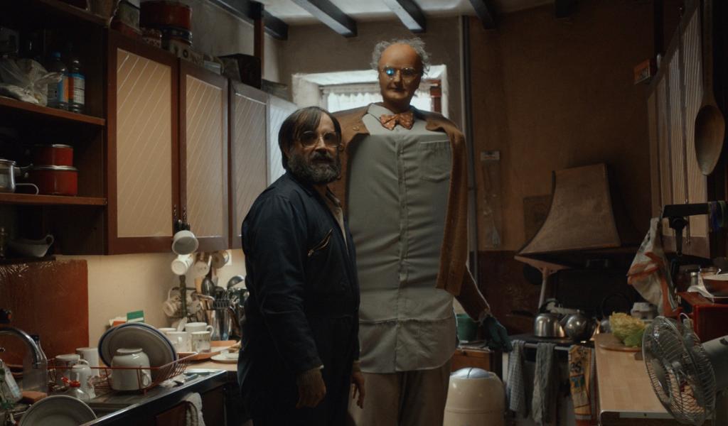 Brian & Charles (PG), Image - David Earl as Brian stands next to his Robot, Charles, a cube like figure with a mannequins head.