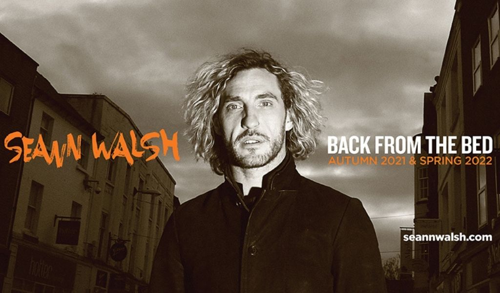 Seann Walsh Back from the Bed, Image - A black and white photo of Seann Walsh stood in a street