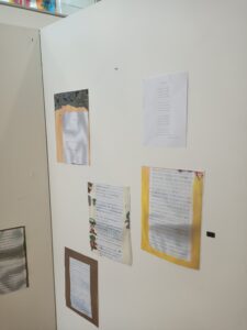An image of space themed work on display on a white wall