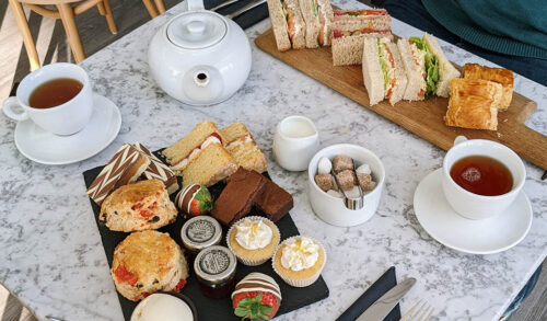 Afternoon Tea  A table with sandwiches tea cakes and scones