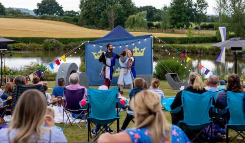 King Arthur Fundraiser  Two people perform in front of a crowd outdoors