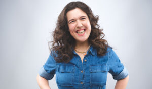 Disabled comedian Rosie Jones smiles at the camera