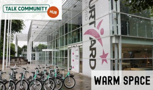 An exterior shot of The Courtyard with the Talk Community Hub logo in the top left corner In the bottom right are the words Warm Space