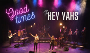Hey Yahs Good Times written over a band performing on stage