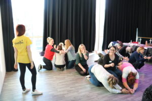 Three groups of people are making different shapes with their bodies