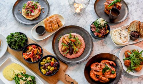 A selection of tapas laid out on a marble table