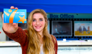 A teenage girl holding a Courtyard Card up to the camera