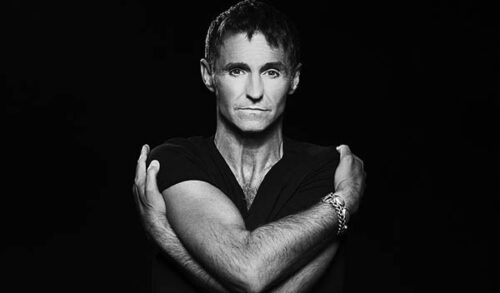MArti PEllow  a black and white photo of a man with his arms wrapped around himself
