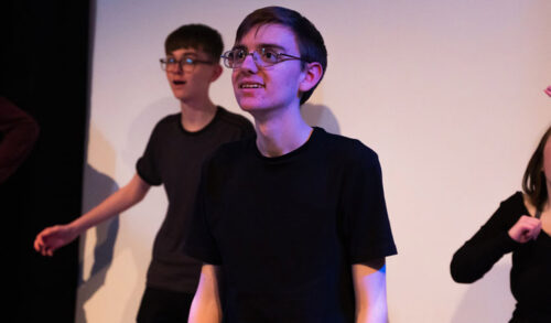 Ewan Connor a teenage boy wearing a black tshirt and glasses