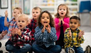 A group of toddlers singing and clapping
