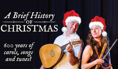 A Brief History Of Christmas  A man and a woman in Santa hats hold instruments and smile