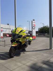 A motorbike outside The Courtyard in the sun