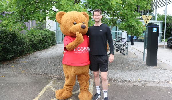 Phil Pearcy and Cookie the mascot bear