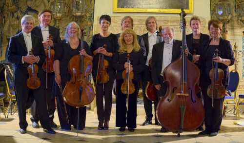 Orchestra Pro Anima An Early Christmas  a group of 10 musicians dressed in formal wear hold instruments whilst stood in a ballroom