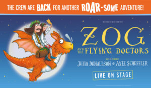 An illustration of one male and one female doctor flying on a dragon across the moon. Writing reads 'Zog and the Flying Doctors. Based on the book by Julia Donaldson & Axel Scheffler. Live on stage. The crew are back for another roar-some adventure!'