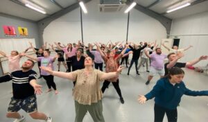 A group of people rehearsing 