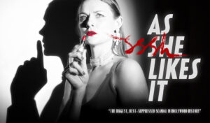 A black and white image of a woman looking concerned and holding red lipstick to her mouth. Writing reads 'As She Likes It'