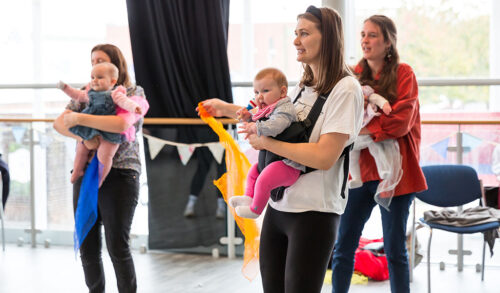 Boogie With Baby  three mums take part in an exercise class with their babies in a sling