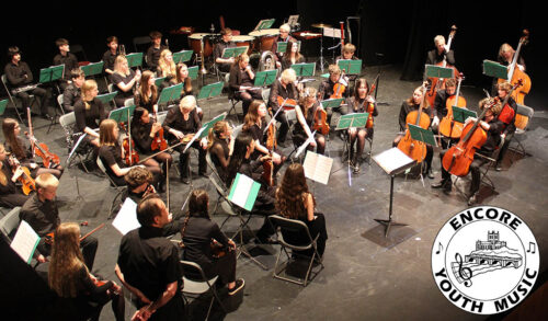 Encore Youth Music Concerts  a photograph of young people on stage performing with instruments