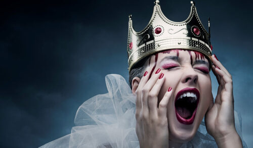 An image of a woman screaming wearing a crown dripping in blood