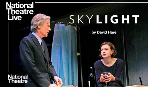 National Theatre Live Skylight Bill Nighy stands in a suit looking at Carey Mulligan across a table She holds a glass of wine
