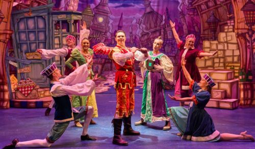 A production shot of actors in Dick Whittington on stage