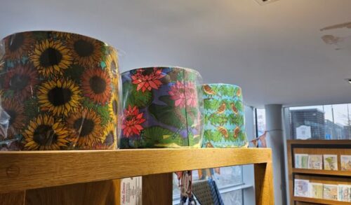 A shelf of patterned lamp shades